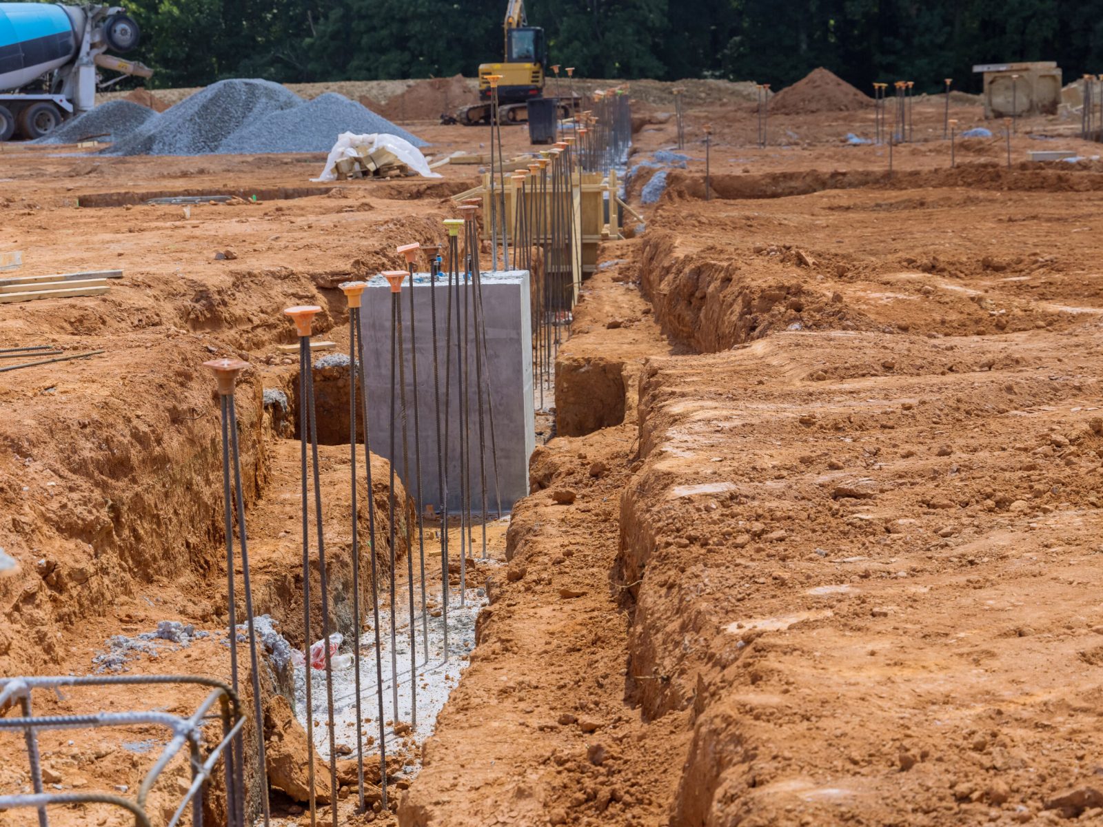 Trench is dug for concrete foundation at construction site trench is reinforced with steel bars rebar wires